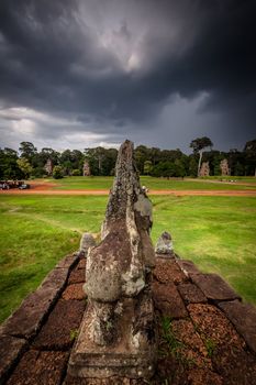 Lion carving of Angkor with stormy sky in the background.