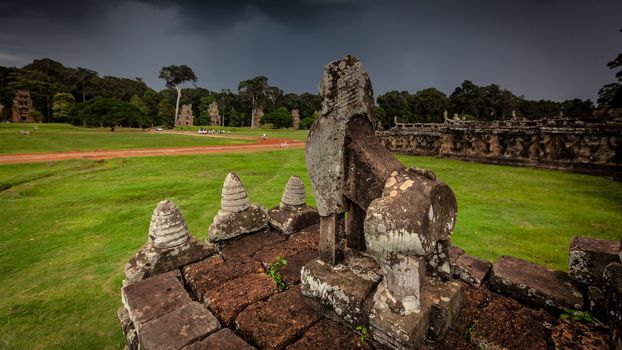 Lion carving of Angkor with stormy sky in the background.