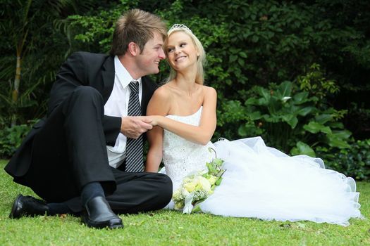 Lovely young couple sitting together on their wedding day