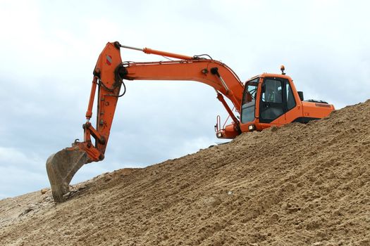Digging machine excavation in a sandy pit