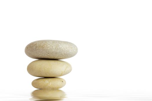 Spa stones and green leaf, isolated on white background.