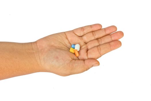 Pills in woman hand isolated on white background