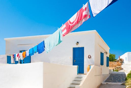 Laundry line with washed clothes outside a Greek island house in the Cyclades
