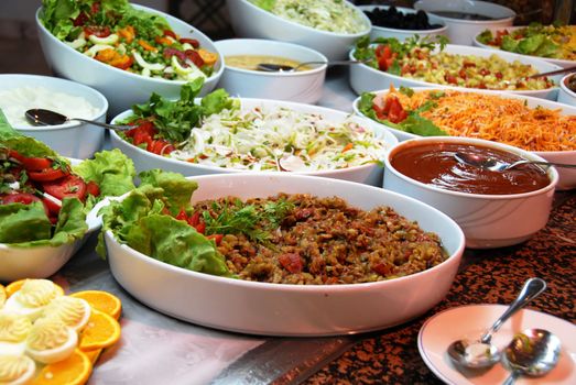 dishes with various salads in buffet restaurant