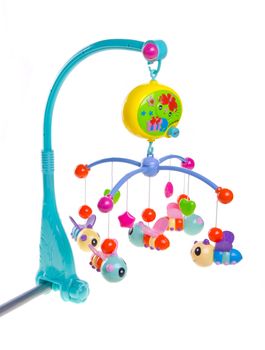 Hanging toy attached to a baby cot. Toys are officially property released.