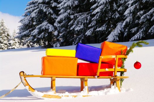 colorful presents on a Santa Claus sledge in a winter landscape