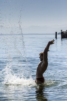 An image of a handsome man having fun in the water