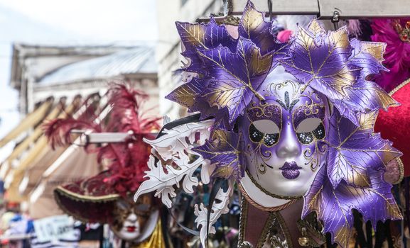 Close-up image of a beautiful Venetian mask on a souvenirs stand in Venice.