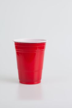 Red plastic glass on a white background