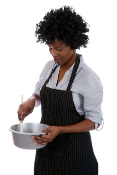 African woman with curly black hair stirring a cooking mixture in a pot
