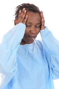 Ill African woman with  thermometer in her mouth and holding her head