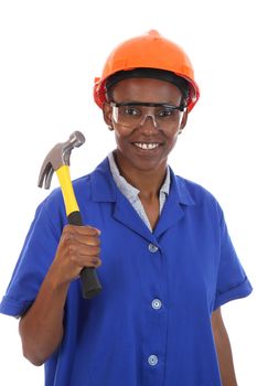 Happy smiling African ethnic lady with hammer and protective safety glasses and hat