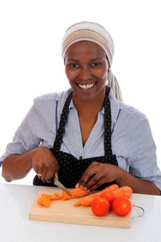 Pretty African housewife preparing vegetables for the family meal