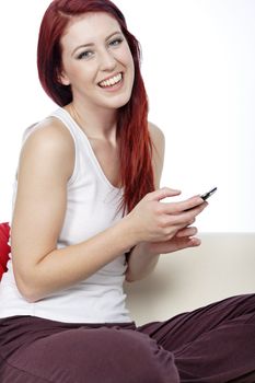 Happy smiling young woman reading texts and laughing.