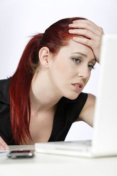 Professional woman showing concern at work using her laptop