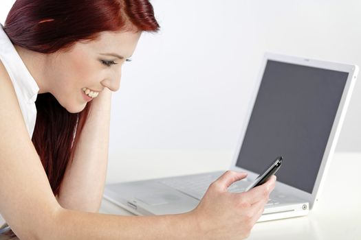 Young woman using her mobile phone at work