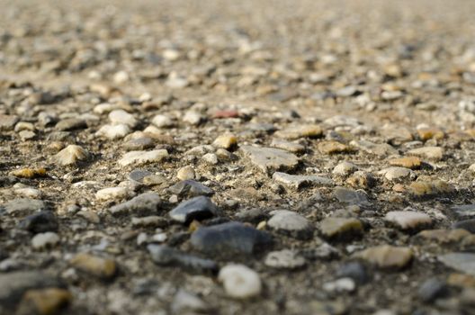 Detail macro view on the structure of a gravel path or street, background structure