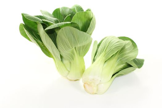 crunchy Asian white-green pak choi on a light background