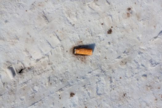 cigarette butt on dirty snow