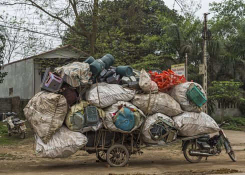 Vietnam Hanoi. Overloaded transport of voluminous stuff makes amazing proposition.