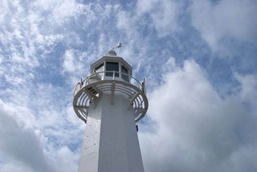A Lighthouse against a blue cloudy sky