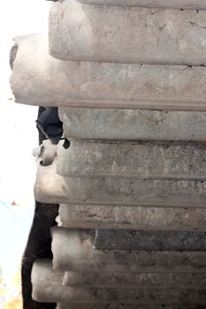 Stack of new pipes in the open air over green grass 