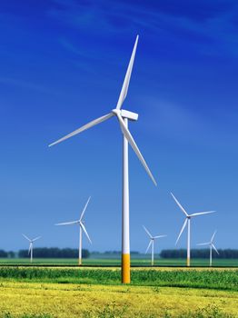 green meadow with Wind turbines generating electricity