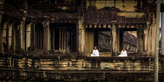 SIEM REAP, CAMBODIA - CIRCA JUNE 2012: unidentified nuns meditate in the quiet morning of Angkor Wat at sunrise circa June 2012 in SIEM REAP, CAMBODIA.