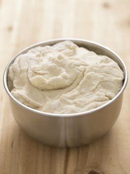 close up of a bowl of flour dough