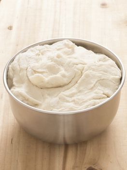 close up of a bowl of flour dough