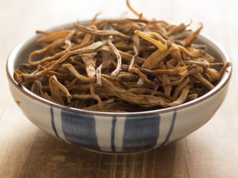 close up of a bowl of dried daylily on table