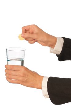 Businesswoman throws a pill from headache to the glass with water