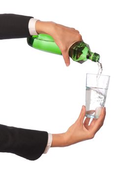 Woman pouring water to a glass from the bottle