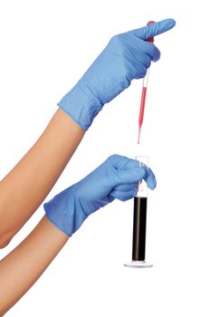 Woman in blue gloves holding sample of fractions of oil typed in a tube for experiments in the hand