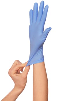 Doctor putting on blue sterilized medical glove for making operation