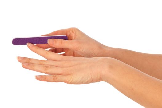 woman files her nails by emery board from manicure set