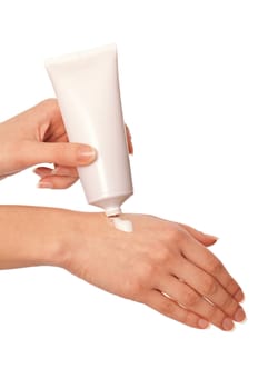 woman lubricates the hands skin with vitaminized cosmetic cream