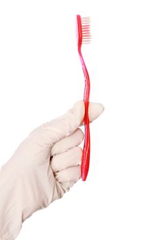 red brush for toothpaste in the doctor's hand