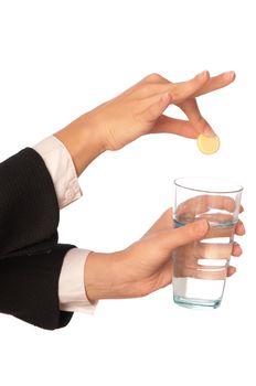 Businesswoman throws a pill from headache to the glass with water