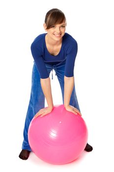 Instructor taking exercise class using ball at gym