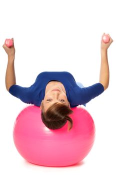 instructor showing exercises using ball and dumbbells at gym to people