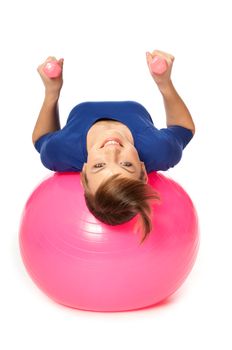 instructor showing exercises using ball and dumbbells at gym to people