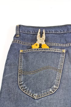 yellow pliers in pocket jeans on white