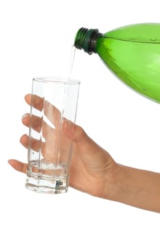 Woman pouring water to a glass from the bottle