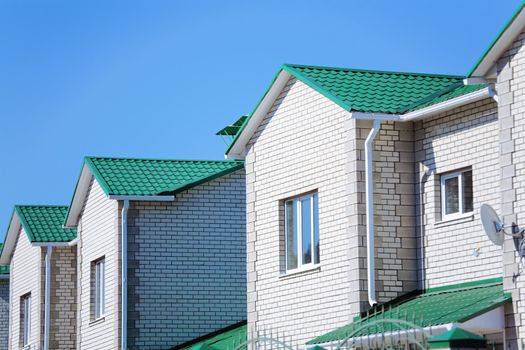 Facades of modern brick townhouses in suburb