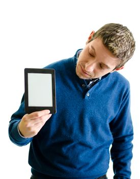 Handsome young man holding ebook reader and looking at it, isolated on white