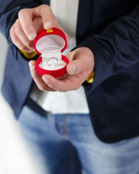 Engagement ring or present in the hands of a man in suit