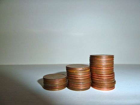 stack of coins on white with shadows