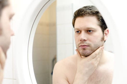 Man looks at his beard and thought about shaving