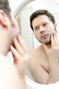Man looks at his beard and thought about shaving